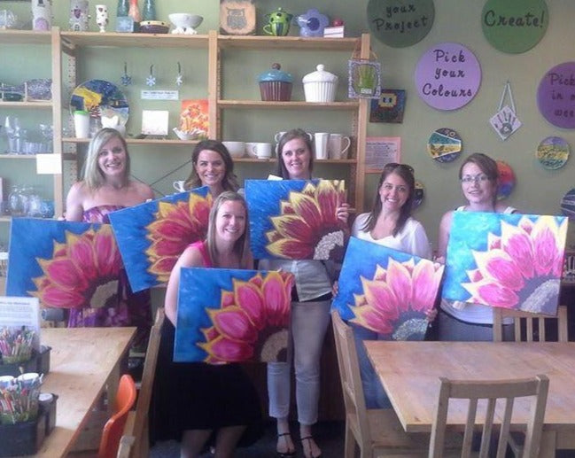 6 Friends holding up their pink flower canvases