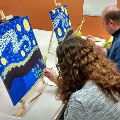 Woman and man painting starry night canvas